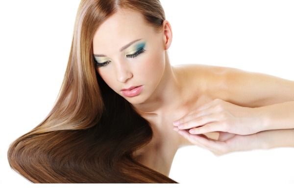 Linda garota com cabelo comprido saudável olhando para baixo no espelho - o que é botox capilar 