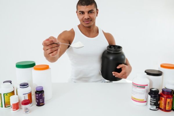 Esportista segurando vitaminas