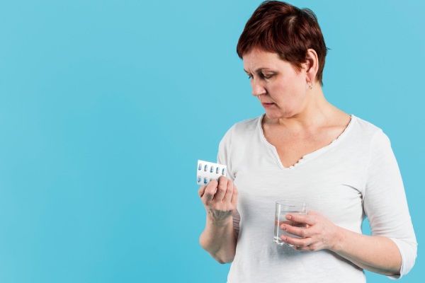Mulher toma medicamentos para tratar alopecia na menopausa 