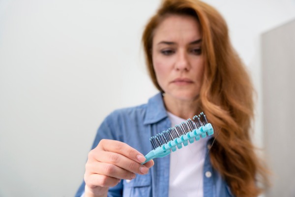 mulher triste e ansiosa com a queda de cabelo